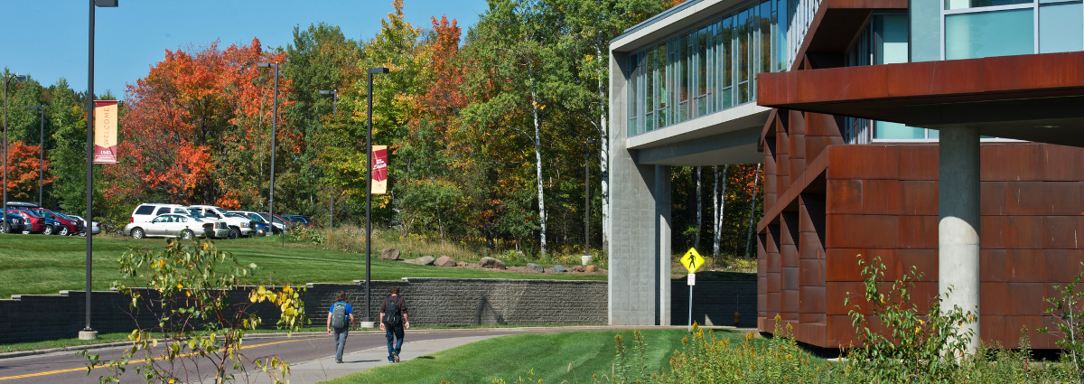 Two students walking outside next to the LSBE building.