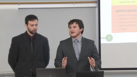 MBA students Eli Drexler and Jonathan Biddick present their project (not shown: Carter Blondel and Brooke Lillie)