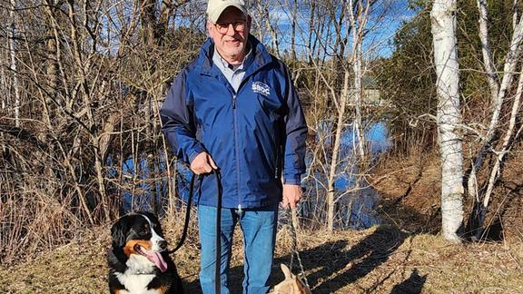 Curt Walczak with his two dogs in the woods. 