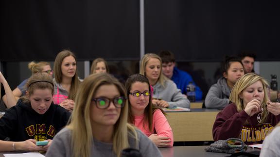 Students in the Long-term Care Course add stickers to their glasses. 