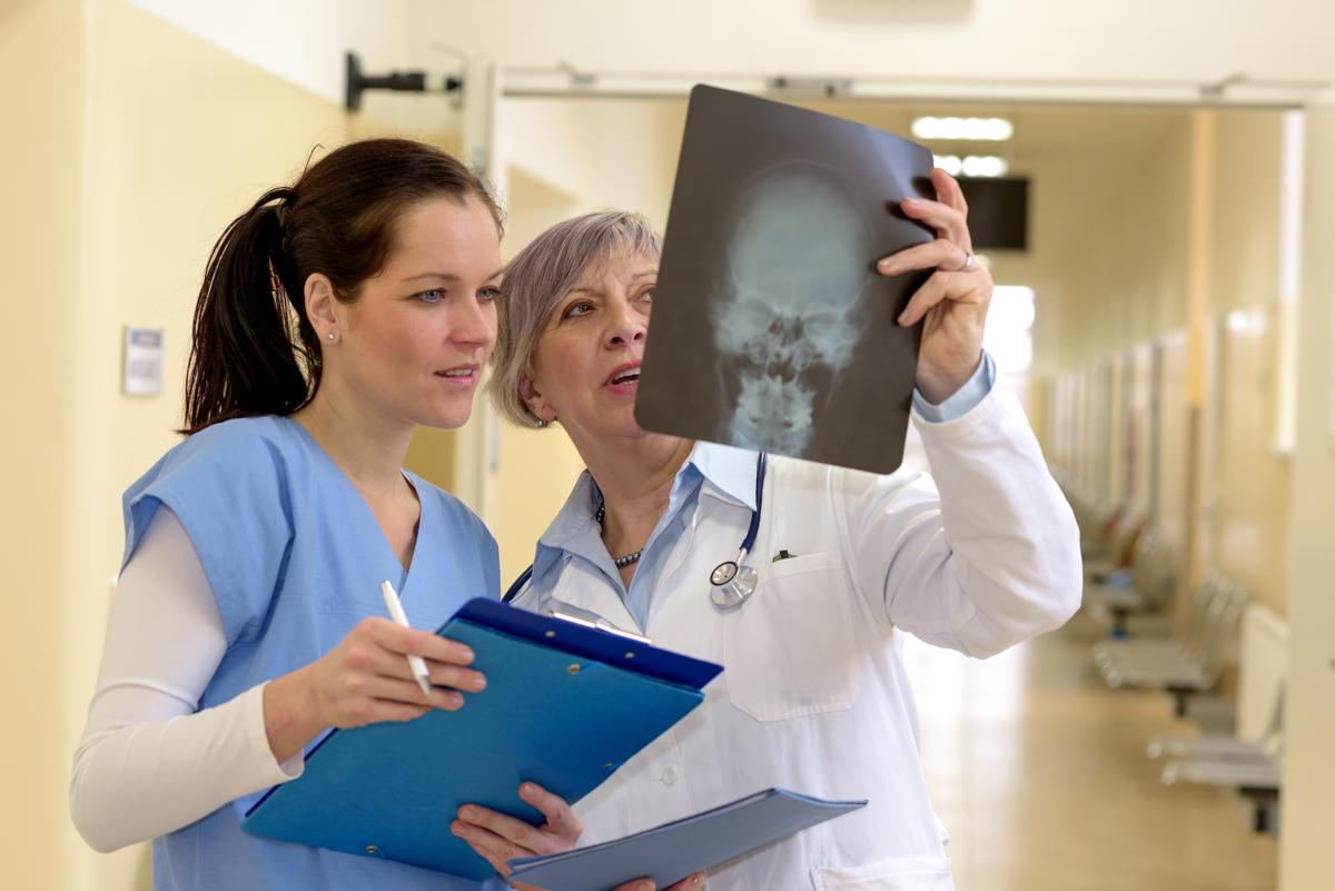 Two female doctors checking patients xray in hospital