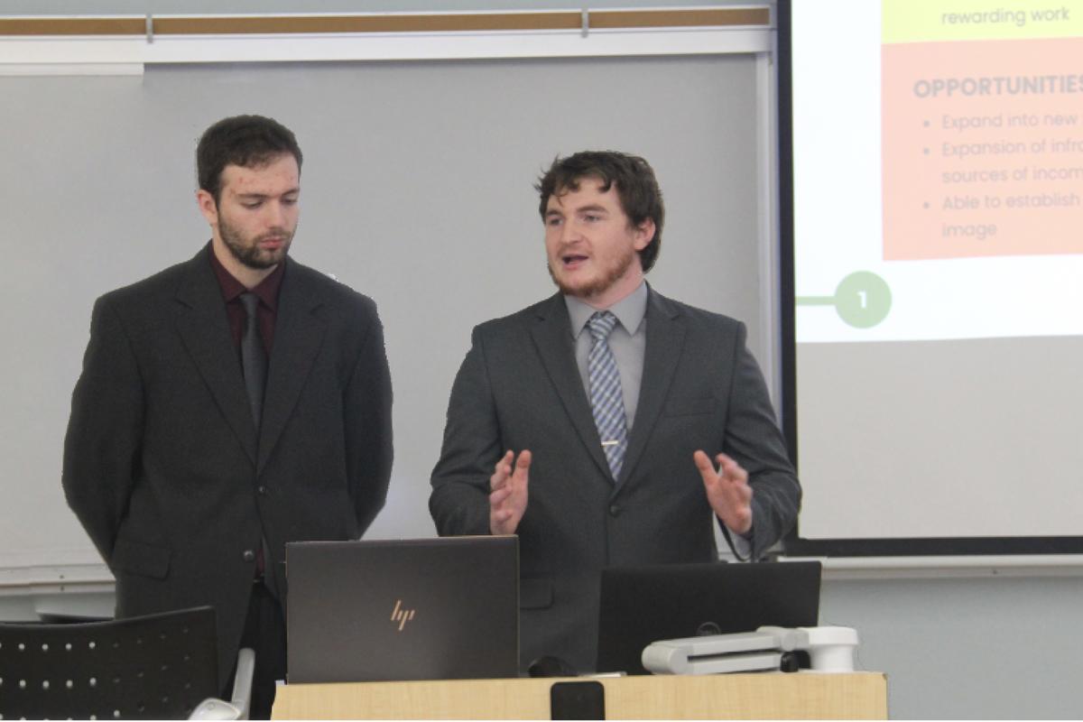 MBA students Eli Drexler and Jonathan Biddick present their project (not shown: Carter Blondel and Brooke Lillie)