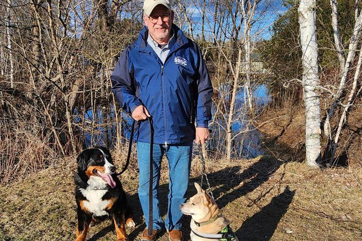 Curt Walczak with his two dogs in the woods. 