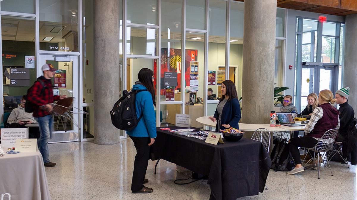 Student talking with an insurance representative in the LSBE atrium