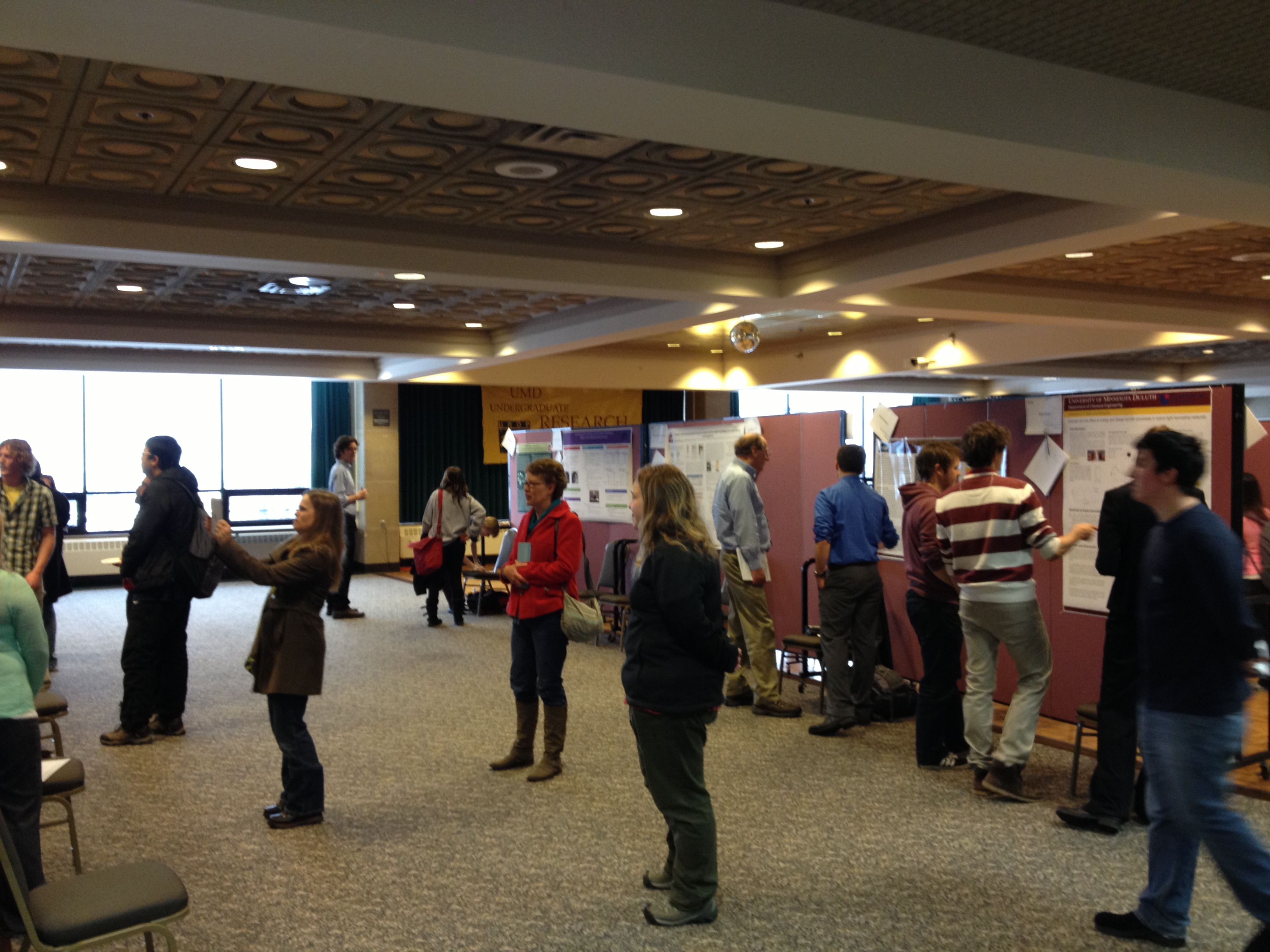 People observing student presentations at the UMD Showcase
