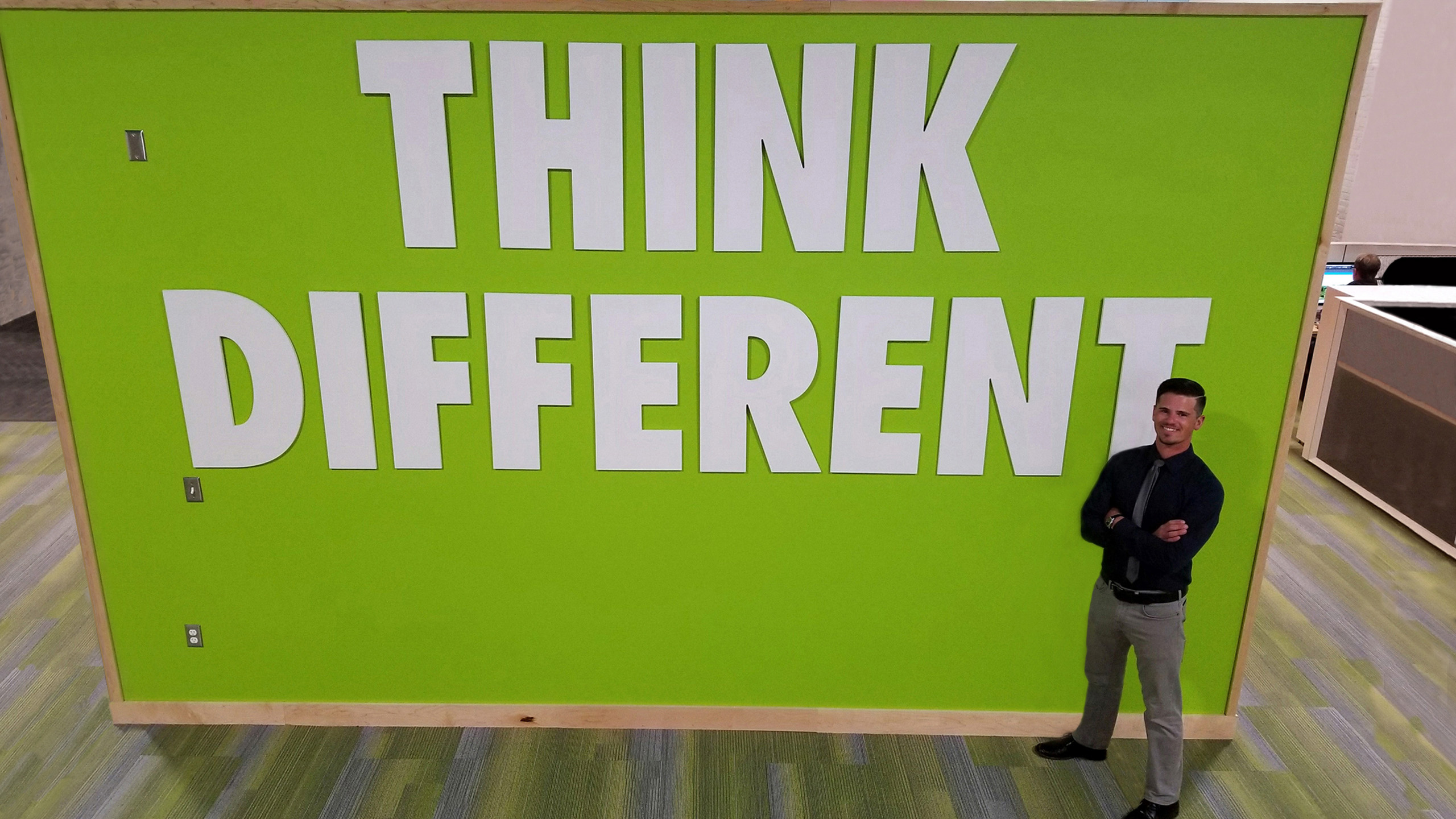 Eli Kohorst in front of "Think Different" sign 