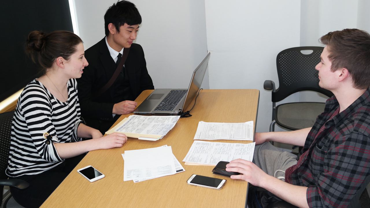 VITA students assisting a person with his 2015 income taxes